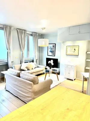 a living room with two couches and a fireplace at Beautiful 2 bedroom familiar luxury apartment in Brussels