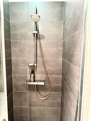 a shower with a shower head in a bathroom at Beautiful 2 bedroom familiar luxury apartment in Brussels