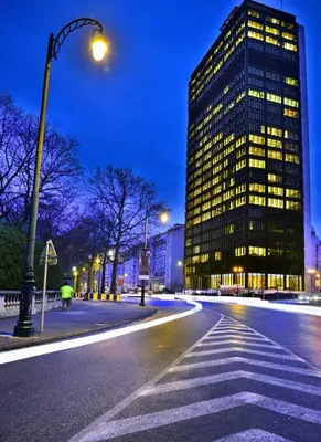 a city street at night with a tall building at Surplombant louisa in Brussels
