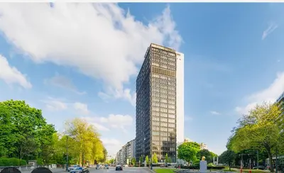 a tall building in a city with a sky at Surplombant louisa in Brussels
