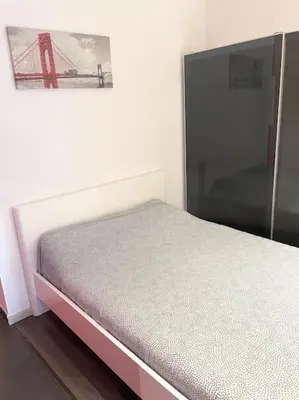 a bedroom with a bed and a painting of a bridge at Appartement in Brussels Centre in Brussels
