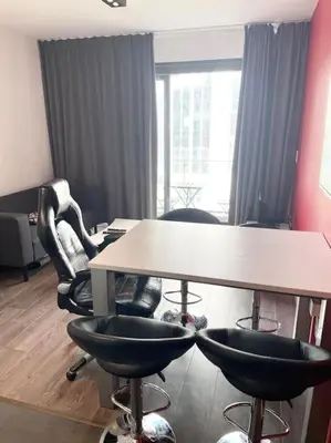 an office with two tables and chairs and a large window at Appartement in Brussels Centre in Brussels