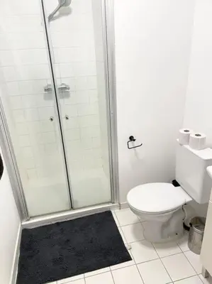 a white bathroom with a shower and a toilet at Appartement in Brussels Centre in Brussels