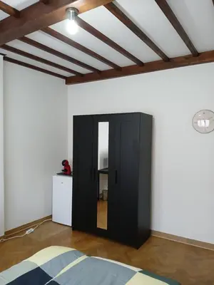 a black cabinet in a room with a ceiling at Assenaar in Asse