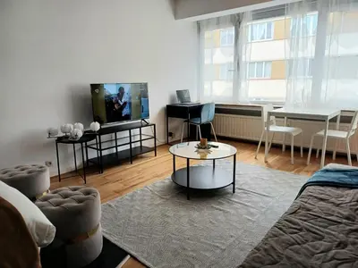 a living room with a couch and a table at Prime Nest Cozy Studio EU Quarter in Brussels