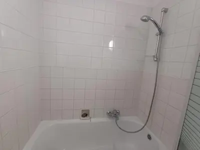 a bathroom with a bath tub with a shower at Prime Nest Cozy Studio EU Quarter in Brussels