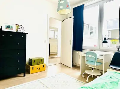 a bedroom with a desk and a bed and a chair at Magnifique appartement spacieux in Brussels
