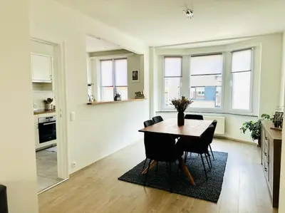a kitchen and dining room with a table and chairs at Magnifique appartement spacieux in Brussels
