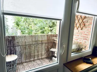 a window with a view of a patio outside at Magnifique appartement spacieux in Brussels