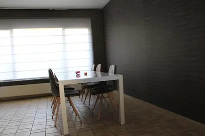 a white table and chairs in a room with a window at Maison Spacieuse near Brussels in Meise