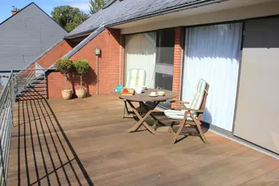 a patio with a table and chairs on a balcony at Maison Spacieuse near Brussels in Meise
