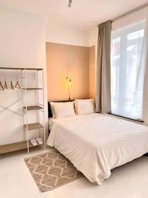 a bedroom with a large bed and a window at Chez Louise - A haven of peace in Brussels in Brussels