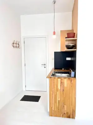 a kitchen with a counter top and a door at Chez Louise - A haven of peace in Brussels in Brussels