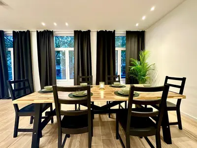 a dining room with a wooden table and chairs at Luxury Suites Park by Rikas Hotels in Antwerp