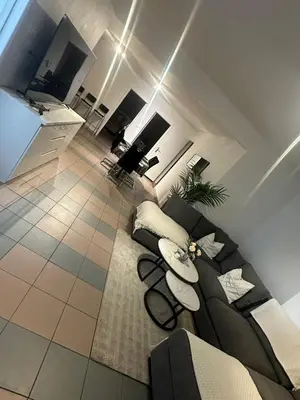 a living room with a couch and a tv at La belle étoile de Bruxelles in Brussels