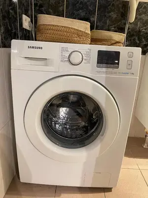 a white washing machine with a basket on top of it at La belle étoile de Bruxelles in Brussels