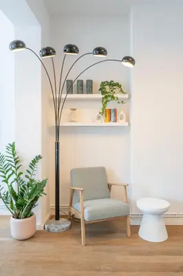 a living room with a chair and a lamp at Your serenity bubble - Brussels center in Brussels