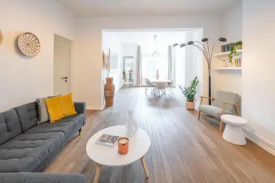 a living room with a couch and a table at Your serenity bubble - Brussels center in Brussels