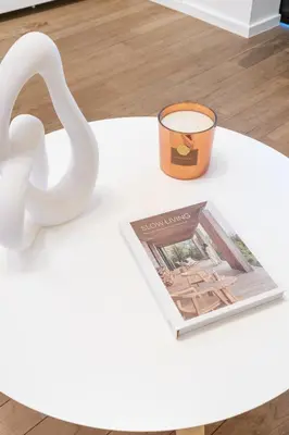 a white table with a candle and a magazine at Your serenity bubble - Brussels center in Brussels