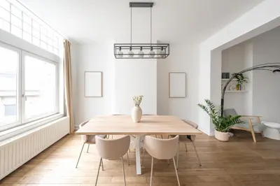 a dining room with a wooden table and chairs at Your serenity bubble - Brussels center in Brussels