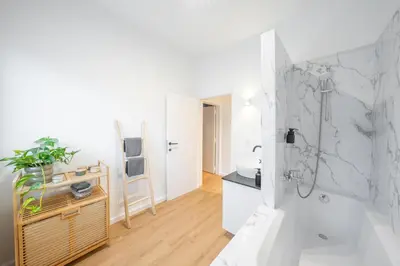 a white bathroom with a shower and a sink at Your serenity bubble - Brussels center in Brussels