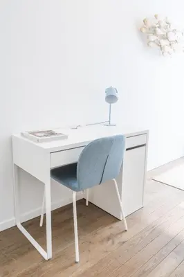 a white desk with a blue chair in a room at Your serenity bubble - Brussels center in Brussels
