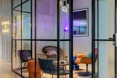 a room with a bunch of chairs and a table at Moxy Antwerp in Antwerp