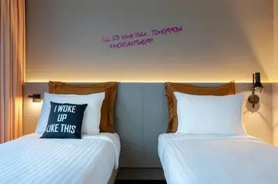 two beds sitting next to each other in a room at Moxy Antwerp in Antwerp