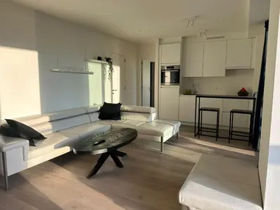 a living room with a couch and a table at Luxurious Apartment with Panoramic View in Antwerp