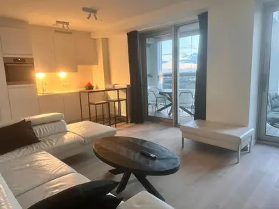 a living room with a couch and a table at Luxurious Apartment with Panoramic View in Antwerp