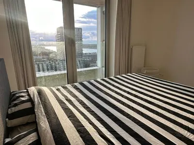 a bedroom with a bed and a large window at Luxurious Apartment with Panoramic View in Antwerp
