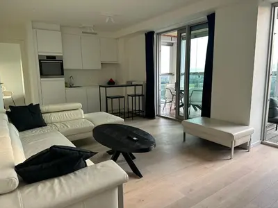 a living room with two couches and a table at Luxurious Apartment with Panoramic View in Antwerp