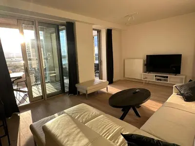 a living room with a couch and a flat screen tv at Luxurious Apartment with Panoramic View in Antwerp
