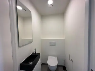 a bathroom with a white toilet and a sink at Luxurious Two Bedroom Apartment in Brussels
