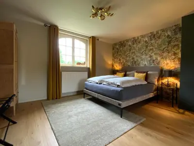 a bedroom with a bed and a window at B&B de Graaf van Poppel in Poppel