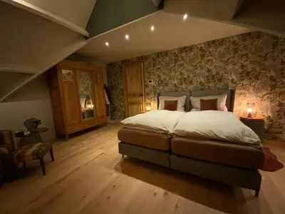 a bedroom with a large bed in a room at B&B de Graaf van Poppel in Poppel