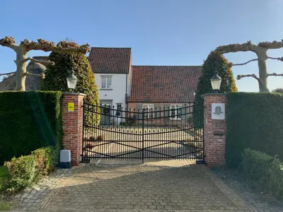 an iron gate in front of a house at B&B de Graaf van Poppel in Poppel
