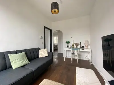 a living room with a couch and a table at Trendy studio at top location in Antwerp