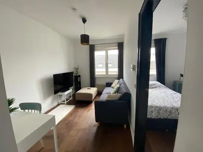 a living room with a couch and a bed at Trendy studio at top location in Antwerp