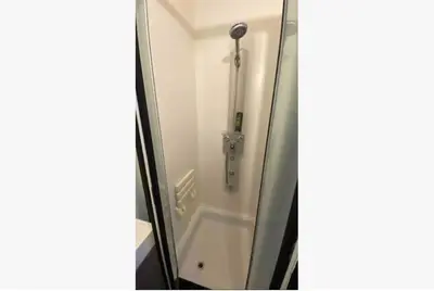 a shower in a bathroom with a glass door at Trendy studio at top location in Antwerp