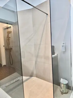 a shower with a glass door in a bathroom at Marianne 1 in Brussels
