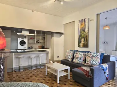 a living room with a couch and a kitchen at Marianne 1 in Brussels