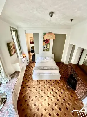 a bedroom with a white bed in a room at Marianne 1 in Brussels