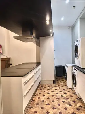 a kitchen with a microwave and a washer and dryer at Marianne 1 in Brussels