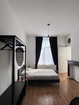 a bedroom with a bed and a window at Studio Nahida in Brussels