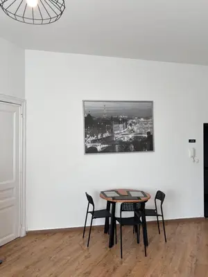 a table and chairs in a room with a picture on the wall at Studio Nahida in Brussels