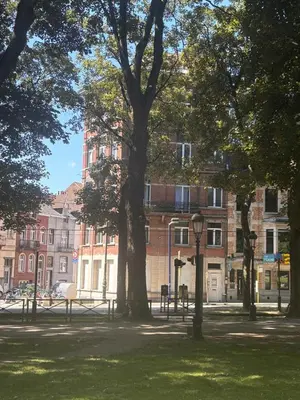 a park with trees in front of a building at Studio Nahida in Brussels