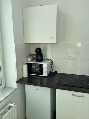 a kitchen with a counter with a toaster and a microwave at Studio Nahida in Brussels