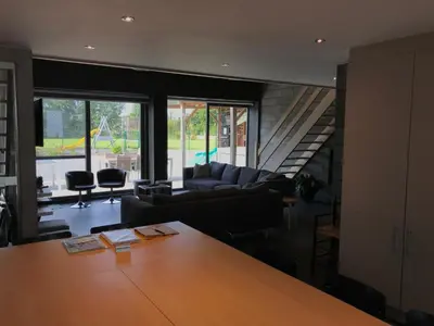 a living room with a couch and a table at Vakantiewoning De Poort in Zottegem