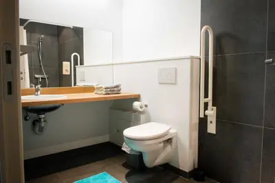 a bathroom with a toilet and a sink at Vakantiewoning De Poort in Zottegem